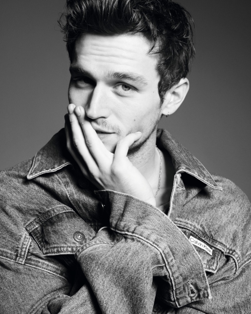 Ready for his closeup, Brandon Flynn rocks a denim trucker jacket for Calvin Klein's 2023 Pride campaign. 