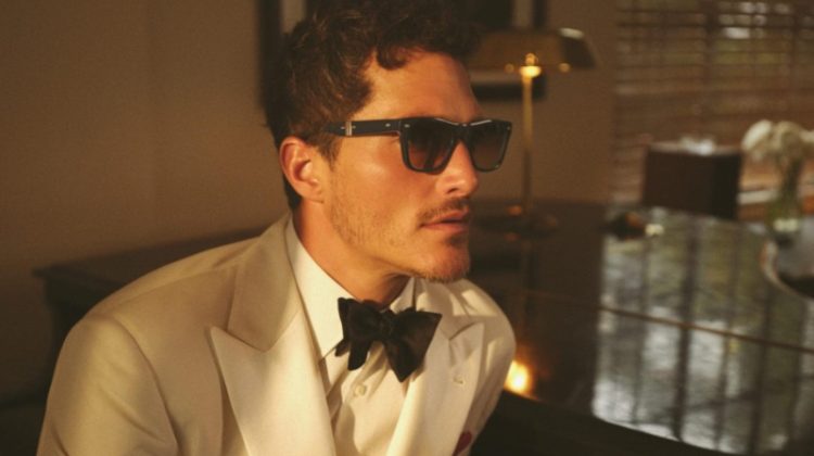 Donning a white tuxedo, Ollie Edwards wears the innovative Mister Brunello Folding sunglasses for the Brunello Cucinelli x Oliver Peoples spring-summer 2023 campaign.