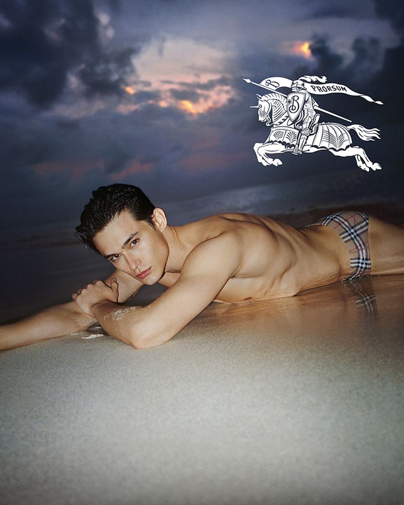 Alex Schlab models check drawcord swim briefs for Burberry's summer 2023 campaign.