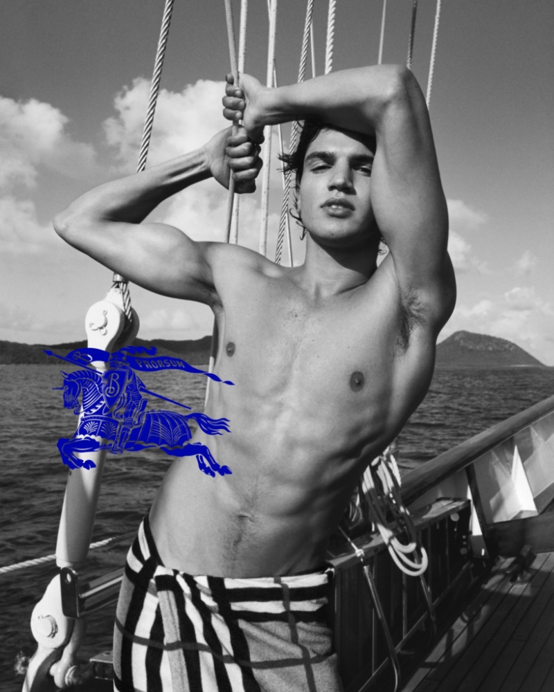 Wrapped in a check cotton towel, Matheus Mesquita stars in Burberry's summer 2023 campaign.