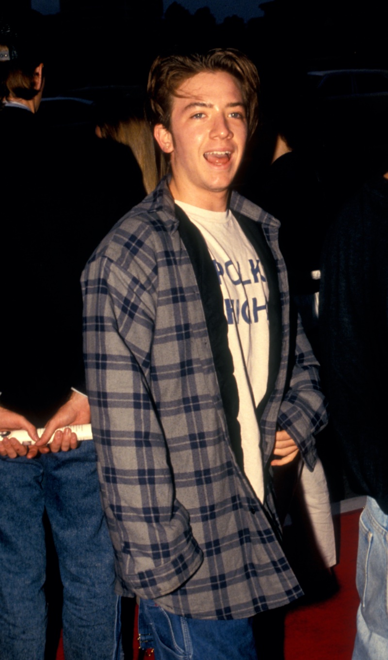 David Faustino of Married with Children fame wears an oversized flannel shirt, outside Roxbury nightclub circa 1991.