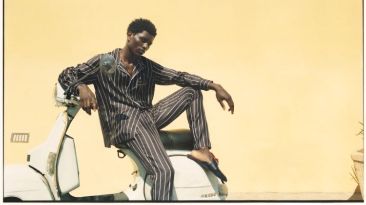 Bah Aziz wears striped silk pajamas from the Dolce & Gabbana x Mytheresa capsule collection.