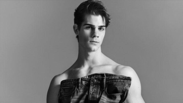 Leonardo Tano sports Emporio Armani underwear briefs as he holds a pair of the label's essential jeans.