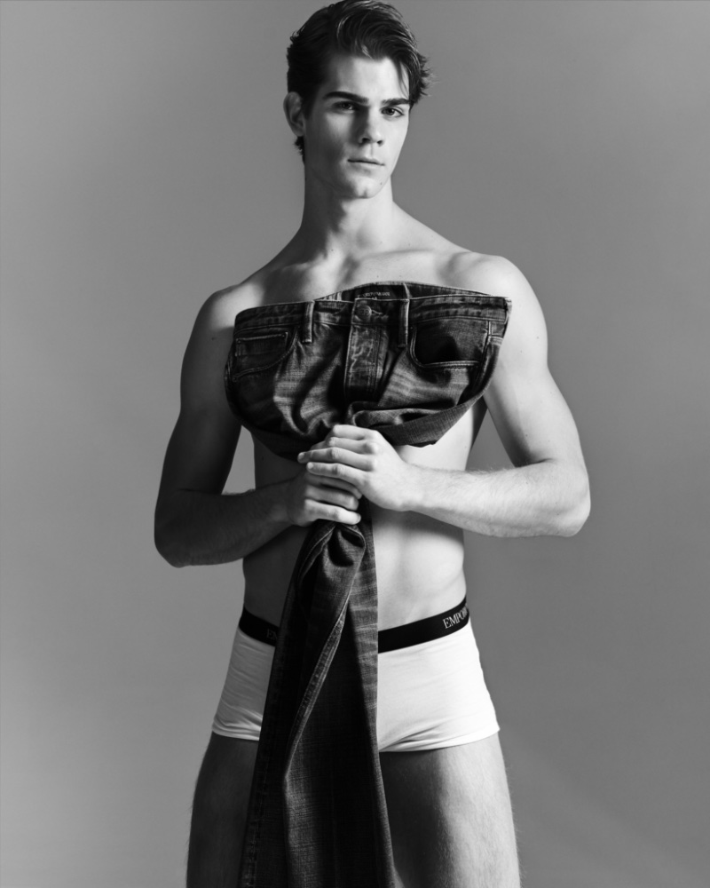 Leonardo Tano sports Emporio Armani underwear briefs as he holds a pair of the label's essential jeans.