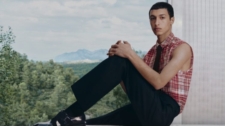Anass Bouazzaoui sports a sleeveless shirt with trousers for Ferragamo's pre-fall 2023 campaign.