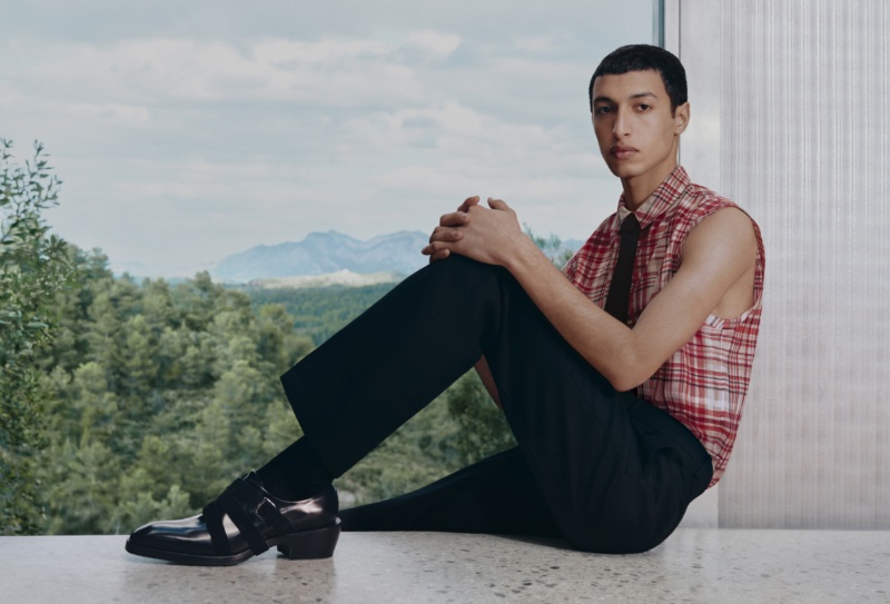 Anass Bouazzaoui sports a sleeveless shirt with trousers for Ferragamo's pre-fall 2023 campaign.