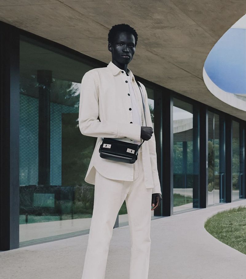 Mamuor Majeng models an all-white look for Ferragamo's pre-fall 2023 campaign. 