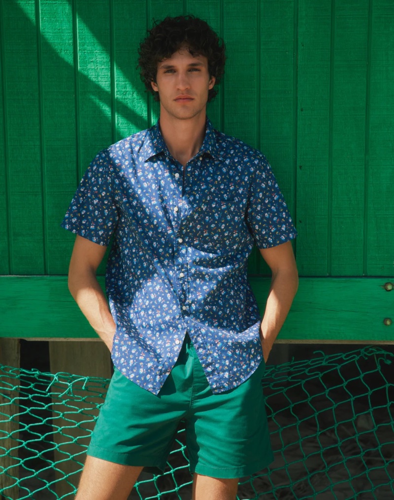Francisco Henriques mixes bold colors in a printed blue shirt with green shorts. 
