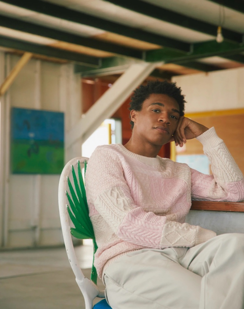 Caleb Giles models a pink cable-knit sweater by J.Crew. 