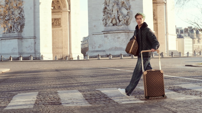 Wearing a monogram Louis Vuitton look, Jackson Wang takes to the streets of Paris for the fashion house's "Horizons Never End" campaign.