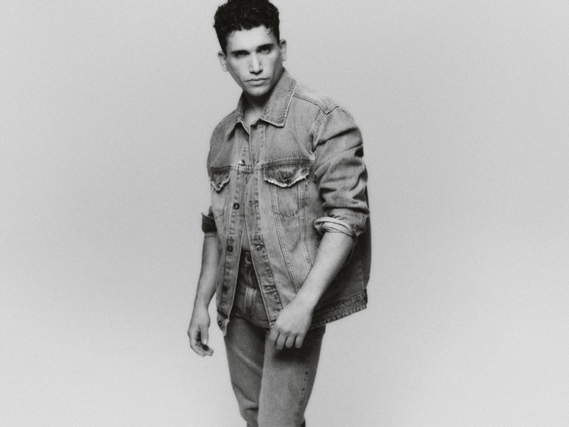 Donning a denim jacket and jeans, Jaime Lorente shows off casual style from his ABOUT YOU collection.