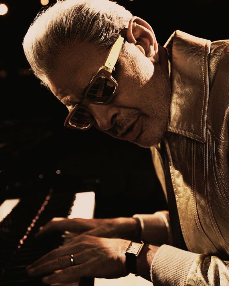 Playing the piano, Jeff Goldblum sports gold JEFF sunglasses from his Jacques Marie Mage collaboration.