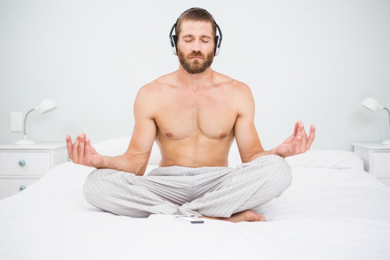 Man Doing Yoga Shirtless Bed Headphones