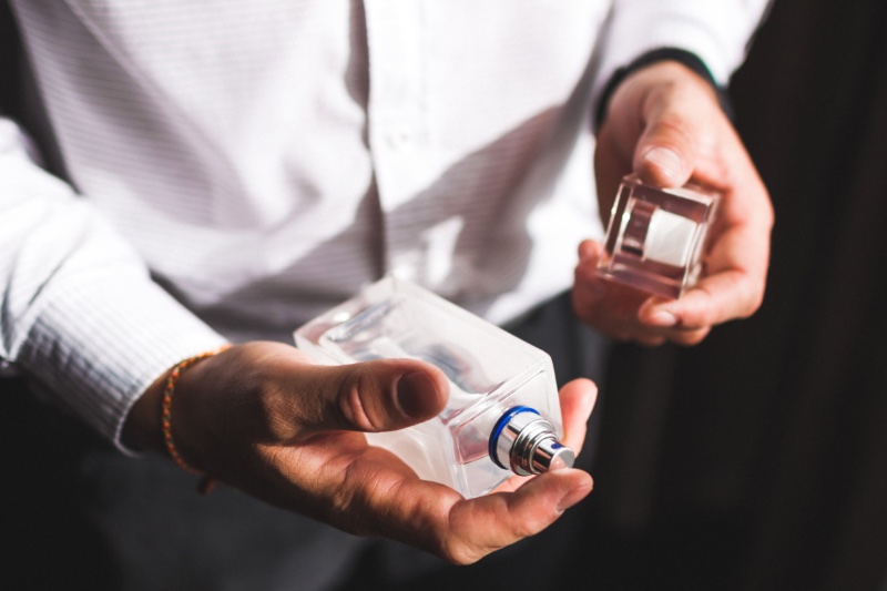 Man Holding Cologne Man Holding Cologne