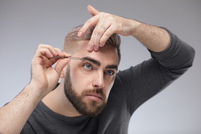 Man Plucking Eyebrows Man Plucking Eyebrows