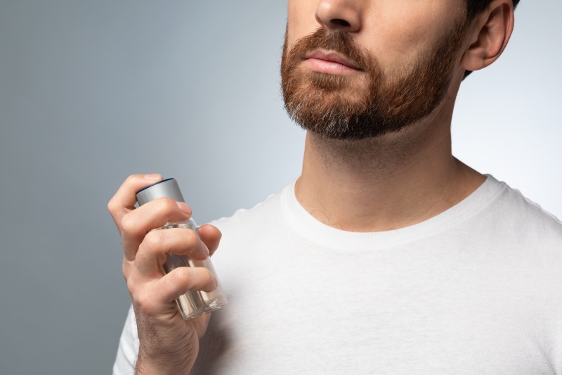 Man Spraying Cologne Crop » The Art of Scent Layering: A Guide for Gentlemen Man Spraying Cologne Crop