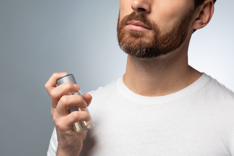 Man Spraying Cologne Crop