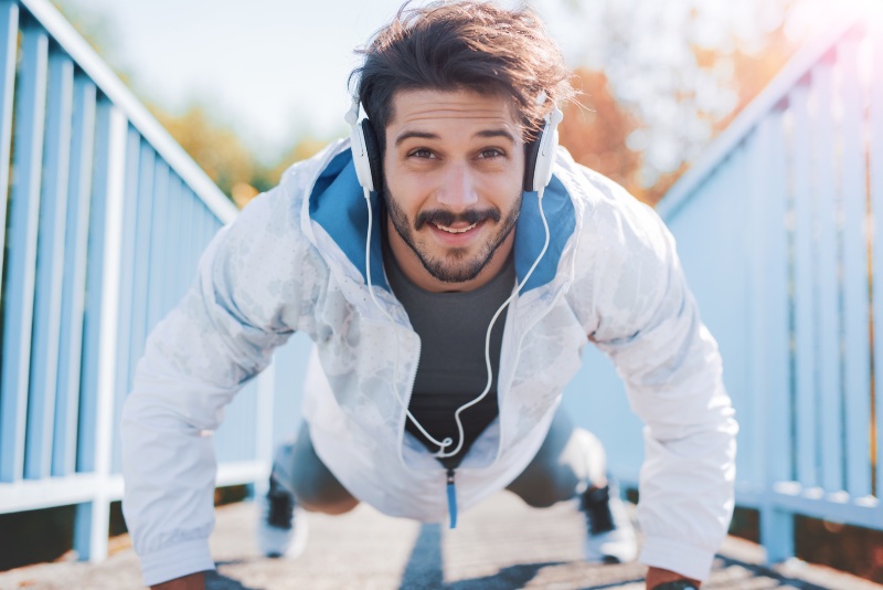 Man Working Out White Jacket Headphones