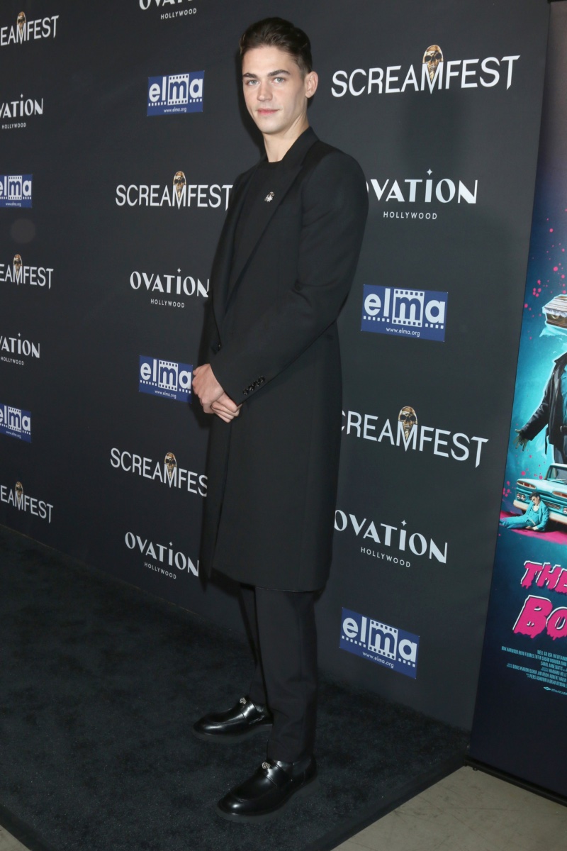 Hero Fiennes-Tiffin wears a tailored coat ensemble by Alexander McQueen to attend the Los Angeles premiere of The Loneliest Boy in the World.