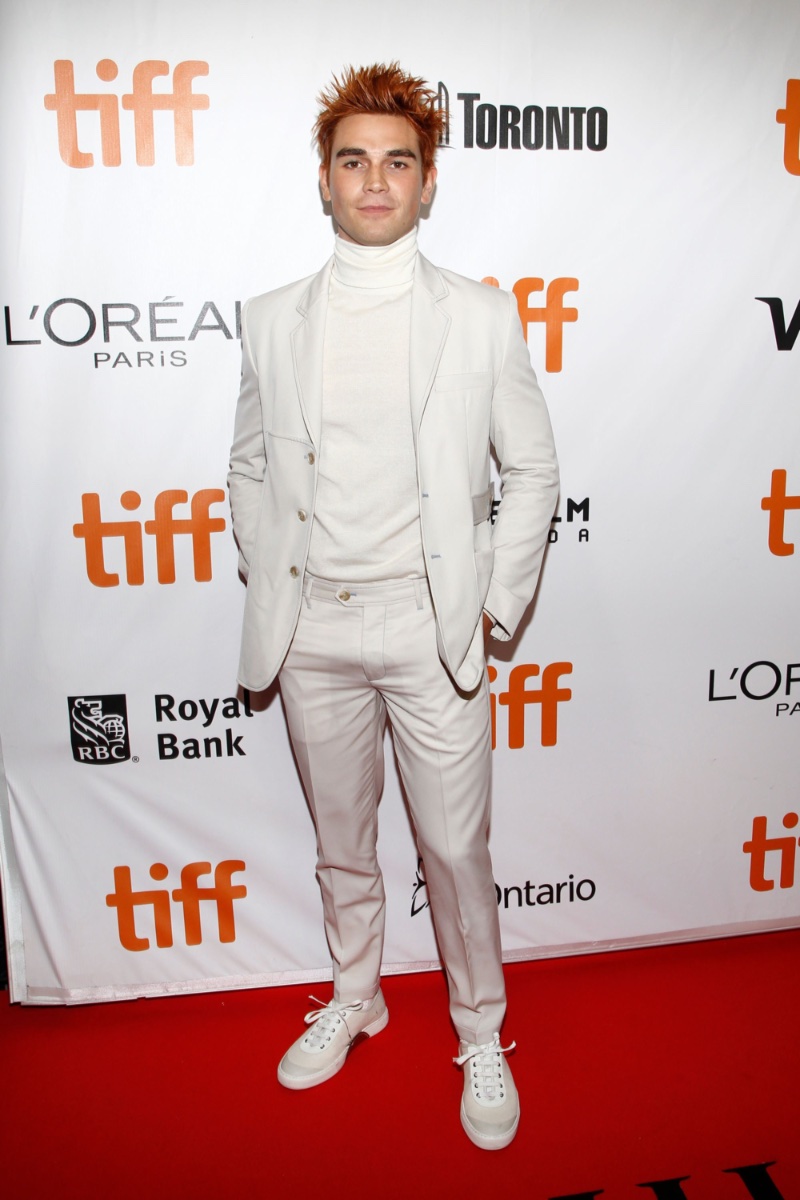KJ Apa embraces monochromatic style in a ivory Victor Li suit with a chic turtleneck as he attends the Toronto premiere of "The Hate U Give." 