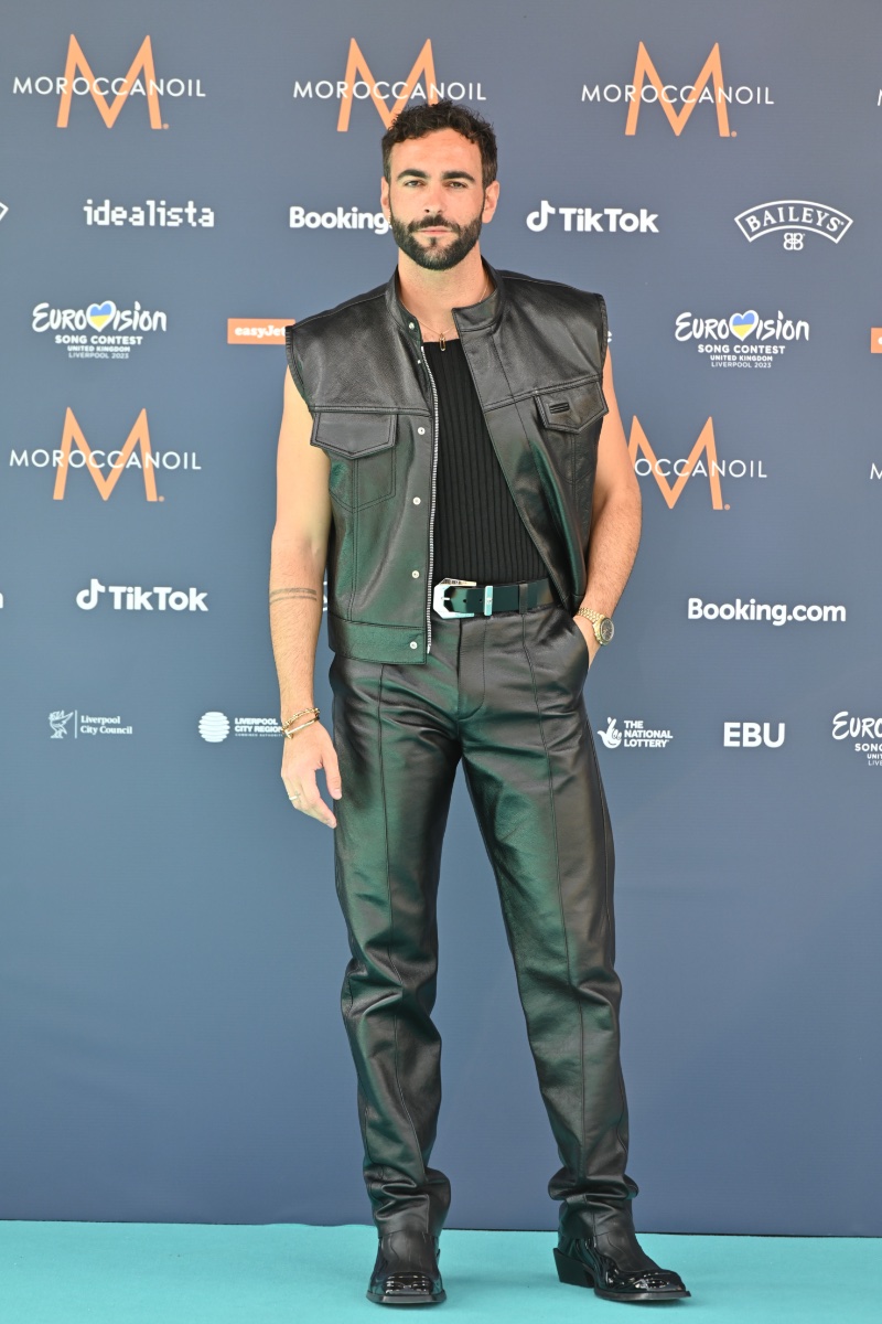 Marco Mengoni steps out in a black outfit at the 2023 Eurovision Song Contest. The singer wears mixes textures in a ribbed-knit sleeveless top with a leather vest and pants from Versace's fall-winter 2023 collection.