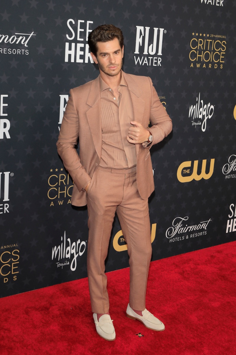 Andrew Garfield makes a splash at the 28th Annual Critics Choice Awards in a monochrome look. Garfield wears a neutral-colored outfit from Zegna with suede loafers.