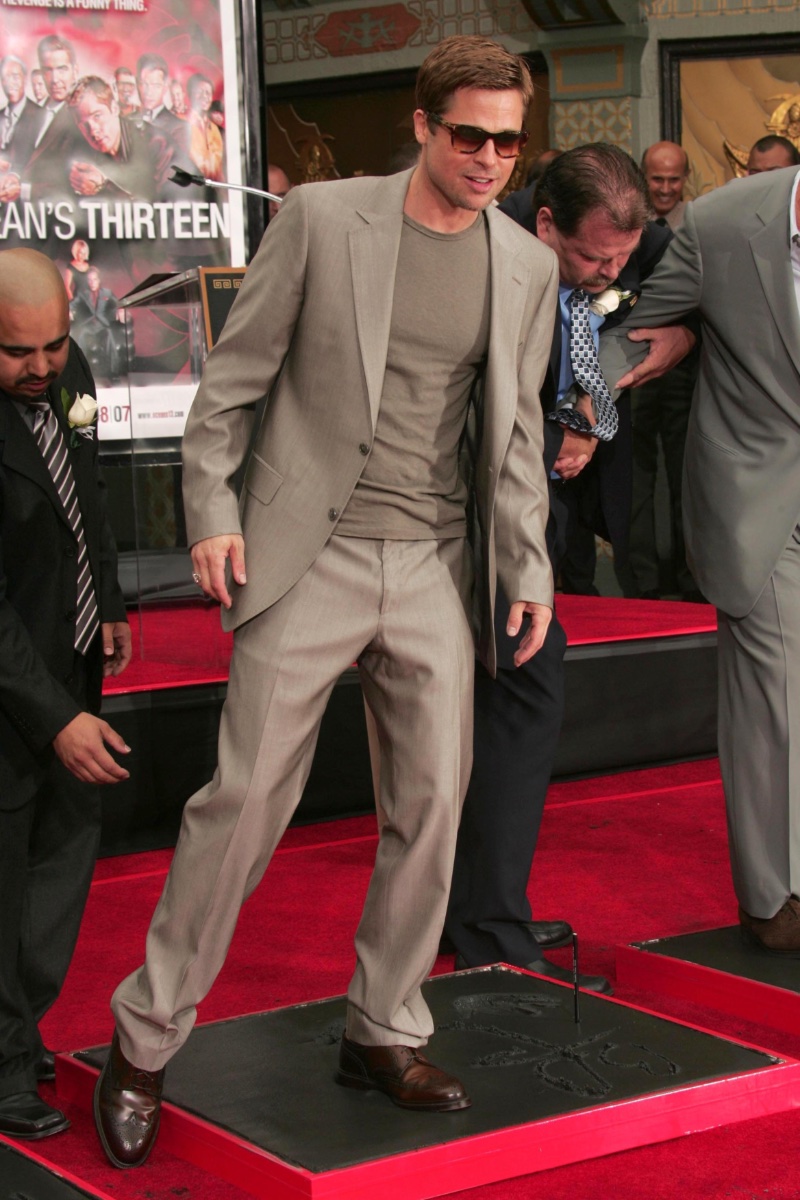 Brad Pitt brings together a monochromatic gray look with brown accessories to attend the Ocean's Thirteen Handprint and Footprint ceremony.