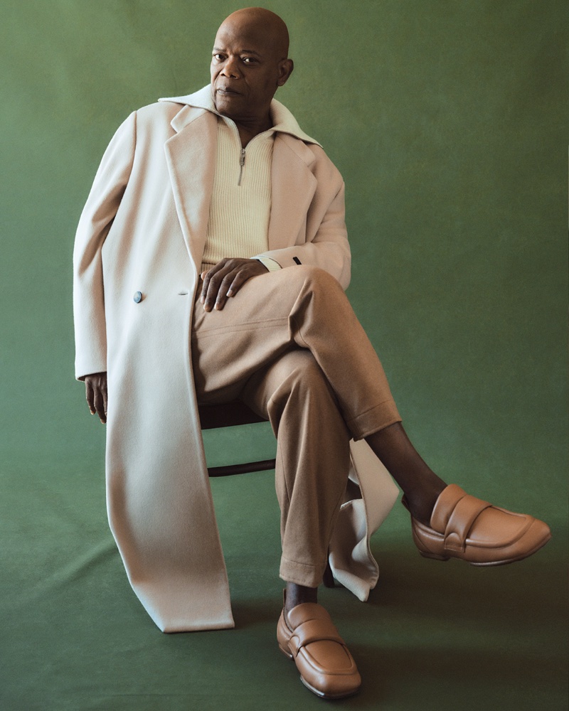A chic vision, Samuel L. Jackson dons a Fear of God oversized double-breasted coat with a RÒHE half-zip sweater, Zegna camel hair and cotton-blend sweatpants, and Dries Van Noten loafers.