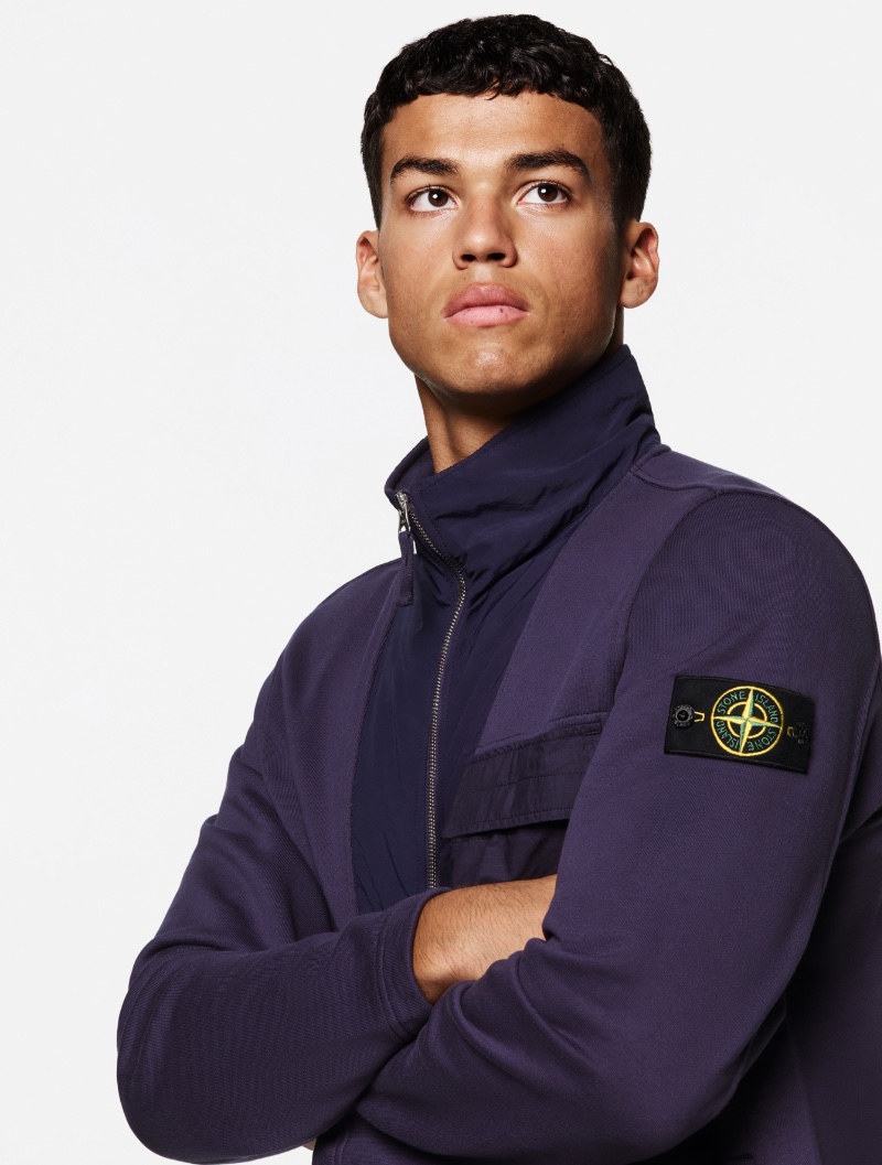Marlow Depeza sports a full-zip sweatshirt from Stone Island's spring-summer 2023 Mix Fabric Hype-TC collection. 