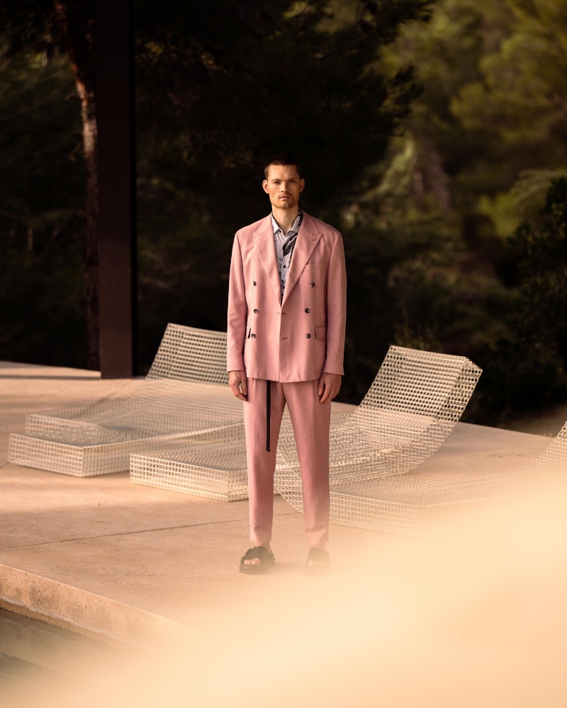 Model William Los wears a pink double-breasted suit for Wormland's spring-summer 2023 campaign. 
