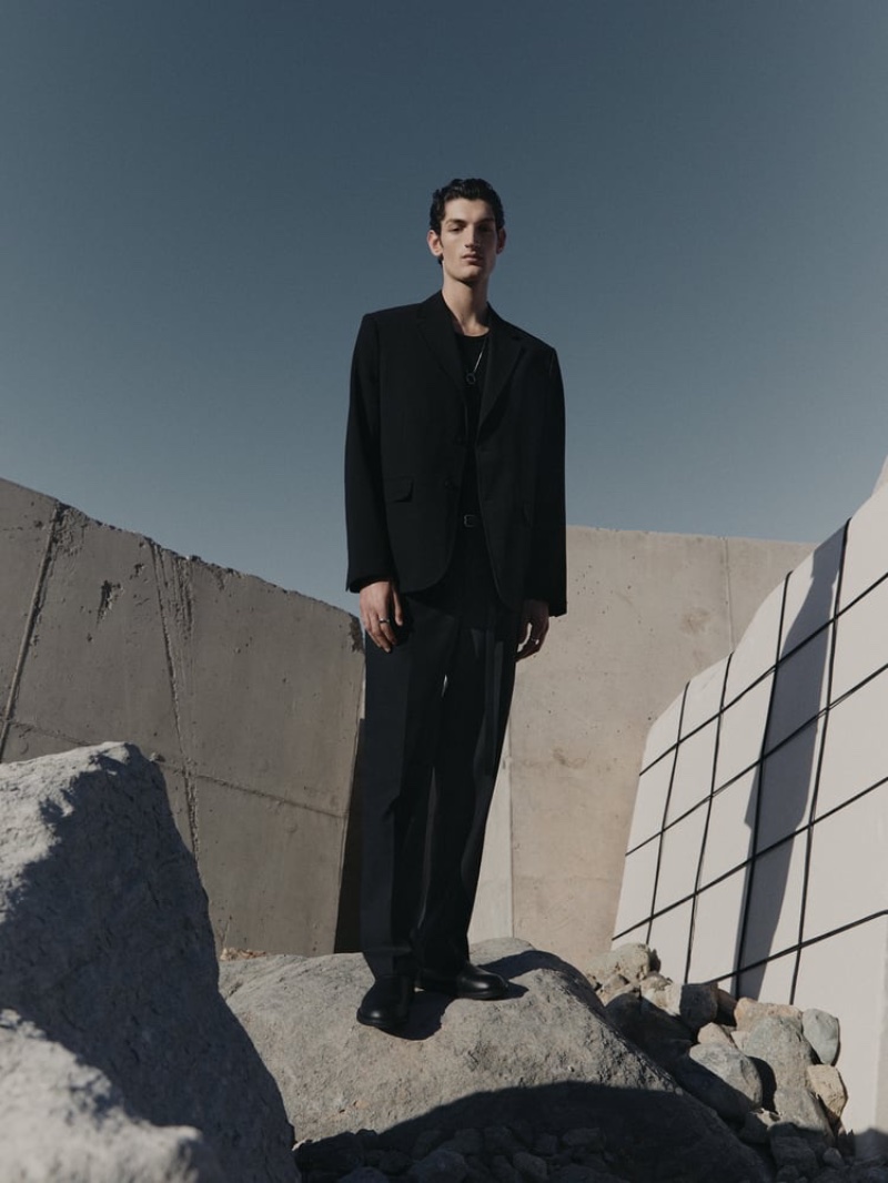 Aaron Shandel dons black tailoring from the Zara Edition spring-summer 2023 collection.