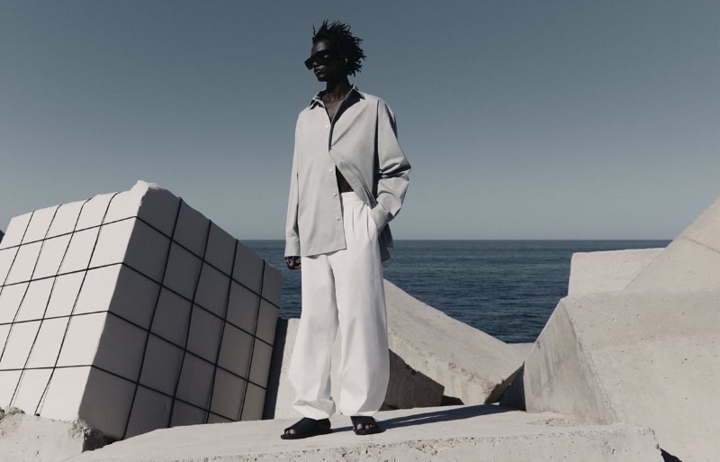 Donning gray and white, Zakaria Dau showcases the relaxed silhouettes of the Zara Edition spring-summer 2023 collection.