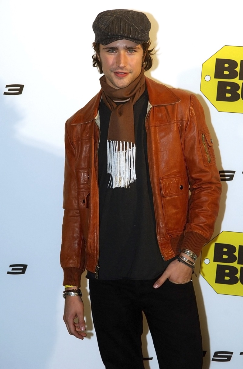 Matt Dallas pairs a scarf with a flat cap and leather jacket for the 2006 launch of Playstation 3 at a West Hollywood Best Buy. 