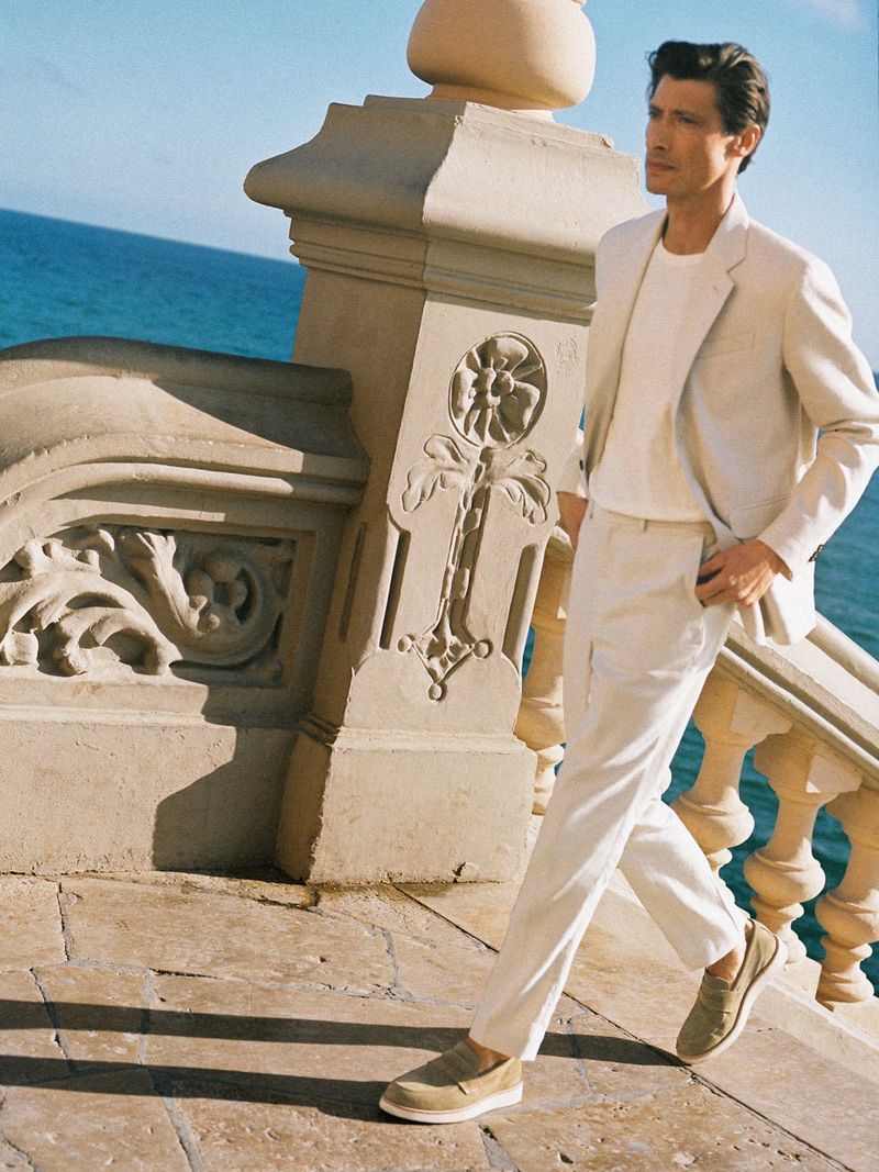 Ready for a beach wedding or a special summer occasion, Jonas Mason dons a neutral-colored suit by ARKET.