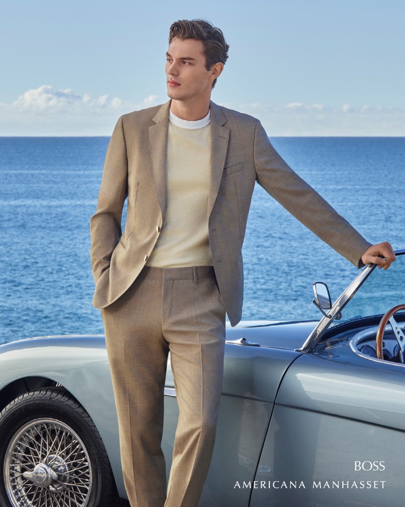 Kit Butler wears a neutral-colored suit by BOSS.