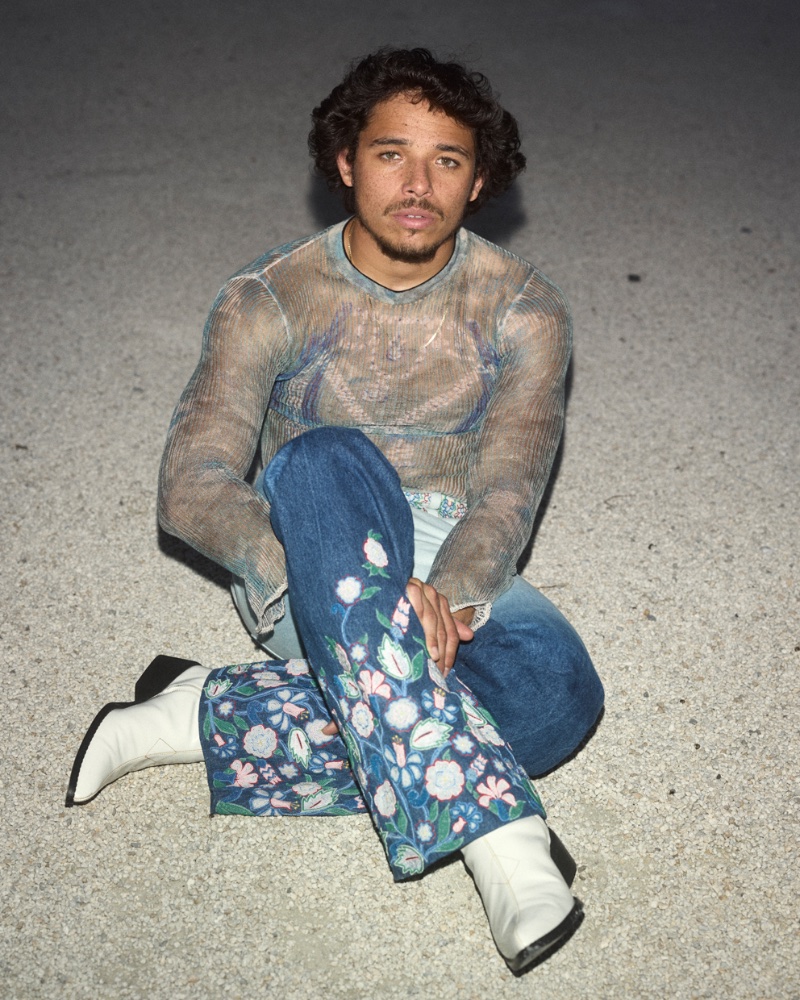 Embracing bold style, Anthony Ramos wears an Acne Studio top with embroidered Casablanca jeans and Alexander Hurley boots.