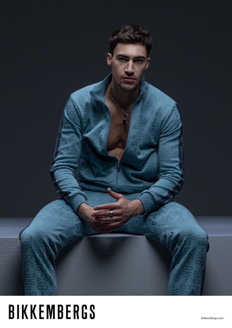 Alessio Pozzi sports a Bikkembergs monogram tracksuit for the brand's fall-winter 2023 campaign.