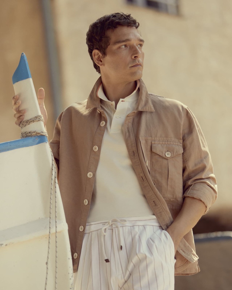 Embracing summer style, Alexandre Cunha dons a Brunello Cucinelli shirt-style outerwear jacket with a jersey polo shirt and double-pleated drawstring trousers. 