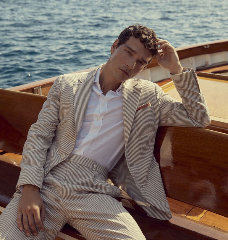 Alexandre Cunha models a Brunello Cucinelli striped linen and virgin wool suit. 