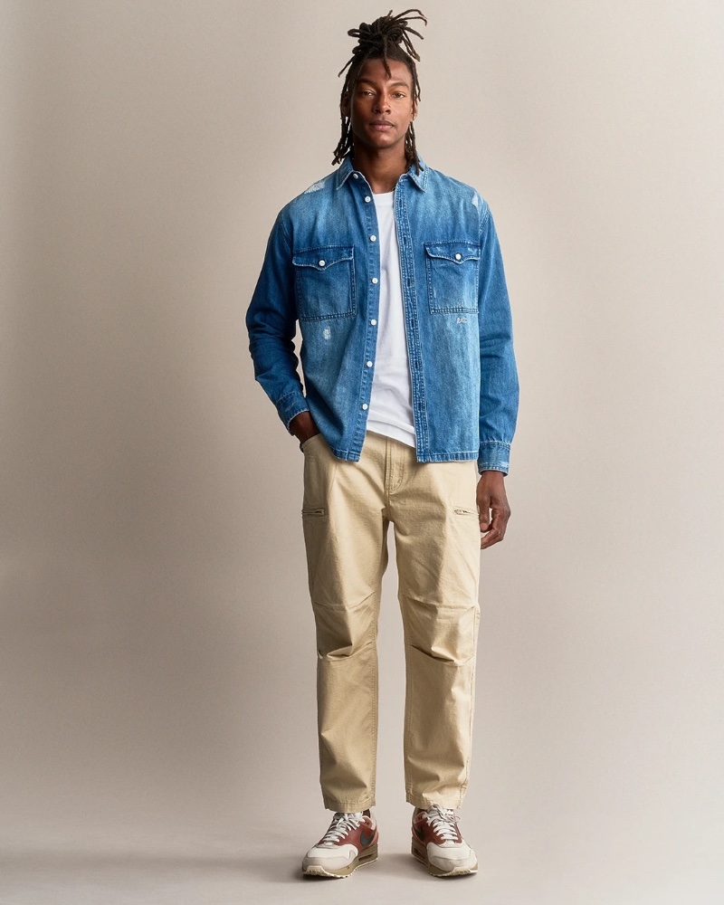 Ty Ogunkoya models denim and khakis from DENHAM's spring 2023 collection.