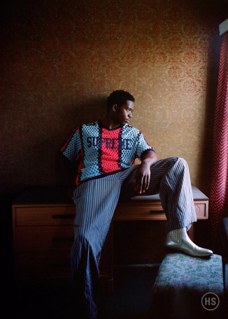 Going casual, Damson Idris wears a Supreme top with Dries Van Noten striped pants and Tom Ford boots.