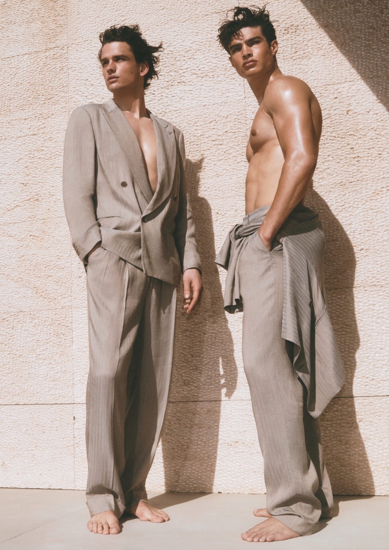 Models Simon Nessman and Noah Luis Brown wear neutral-colored suiting for the Giorgio Armani Mare spring-summer 2023 campaign.