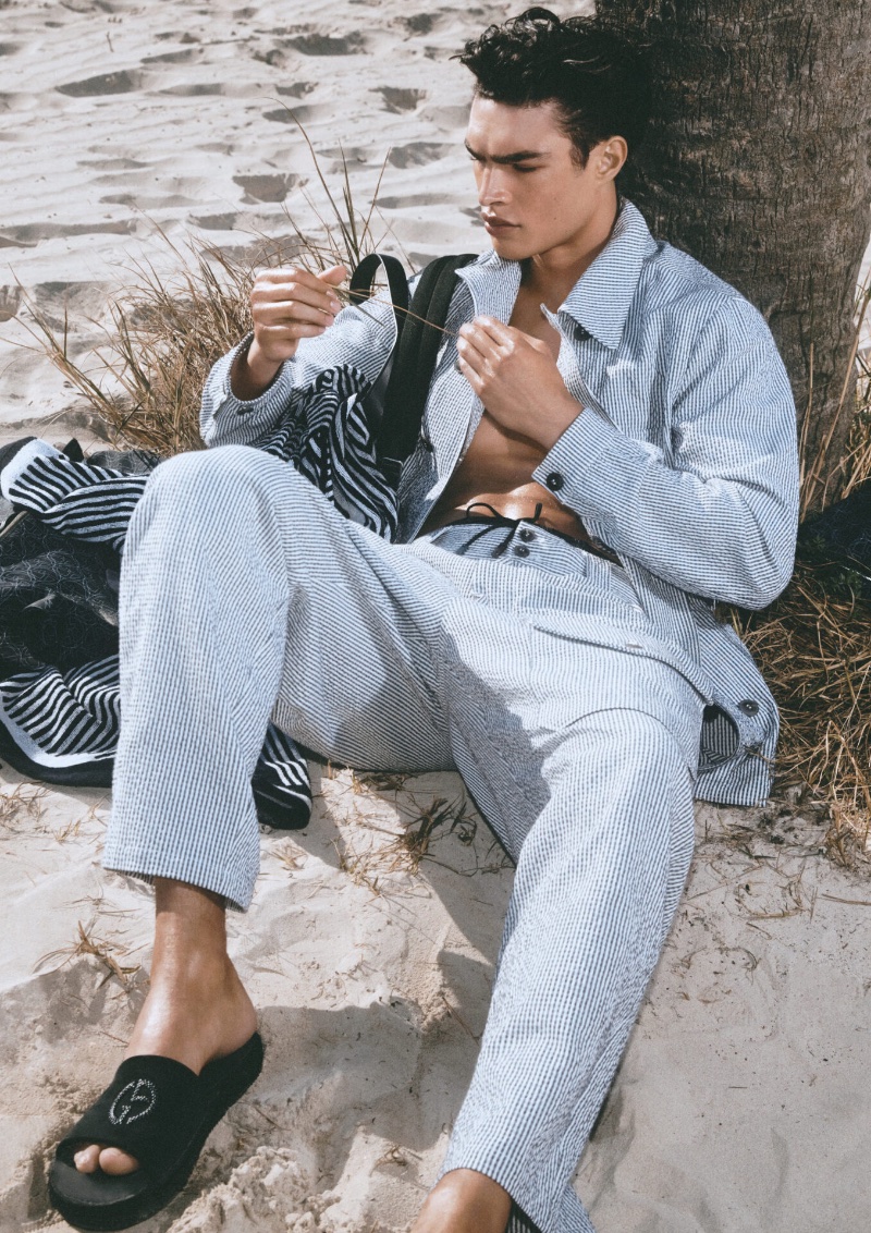 Taking to the beach, Noah Luis Brown wears a striped ensemble for the Giorgio Armani Mare spring-summer 2023 campaign.