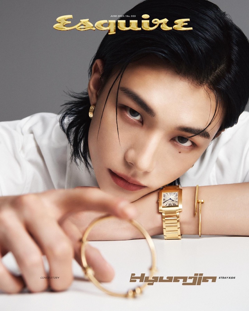 Dressed in a crisp white shirt by Lesugiatelier, Hyunjin dons a Tank Française Cartier watch with the brand's yellow gold Juste un Clou bracelet and love earrings.