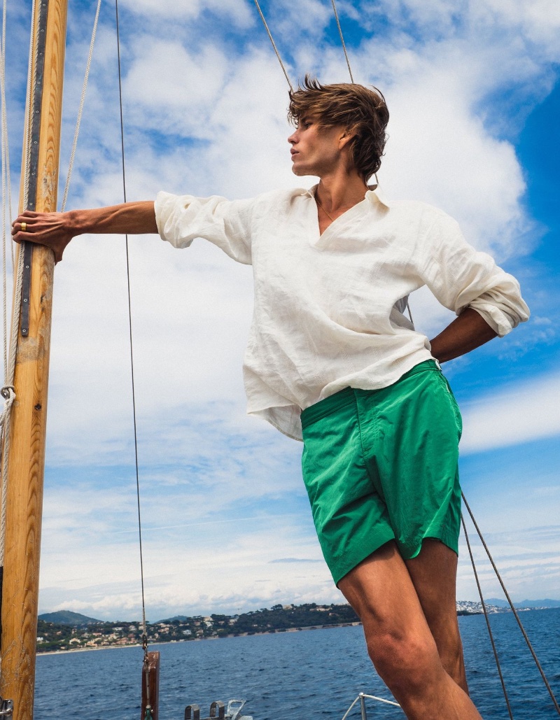 Jordan Barrett wears a Shanklin overhead shirt with kale tonic mid-length swim shorts from his Orlebar Brown collaboration.