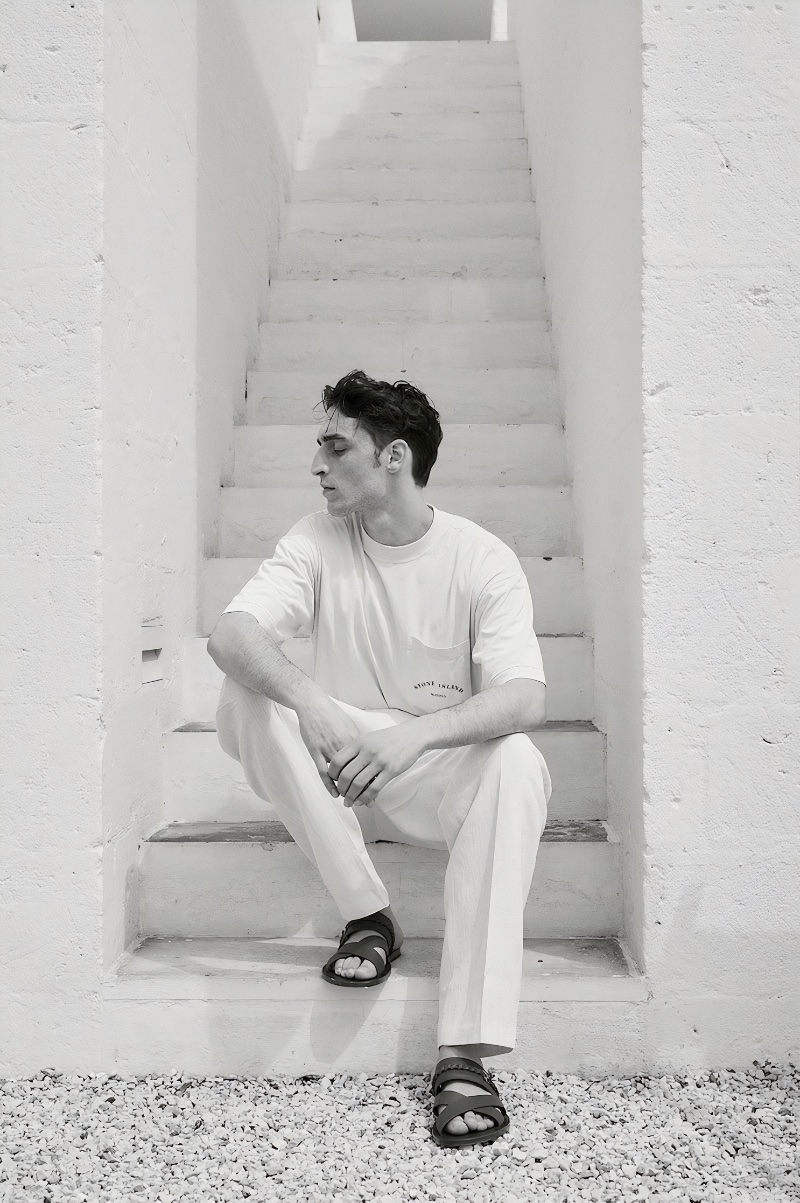 Appearing in a black-and-white photo, Luca Jamal sports a Stone Island Marina printed t-shirt with Jacquemus wide-leg pants and Ferragamo leather sandals. » Luca Jamal Eases Into Summer with LuisaViaRoma Appearing in a black-and-white photo, Luca Jamal sports a Stone Island Marina printed t-shirt with Jacquemus wide-leg pants and Ferragamo leather sandals.
