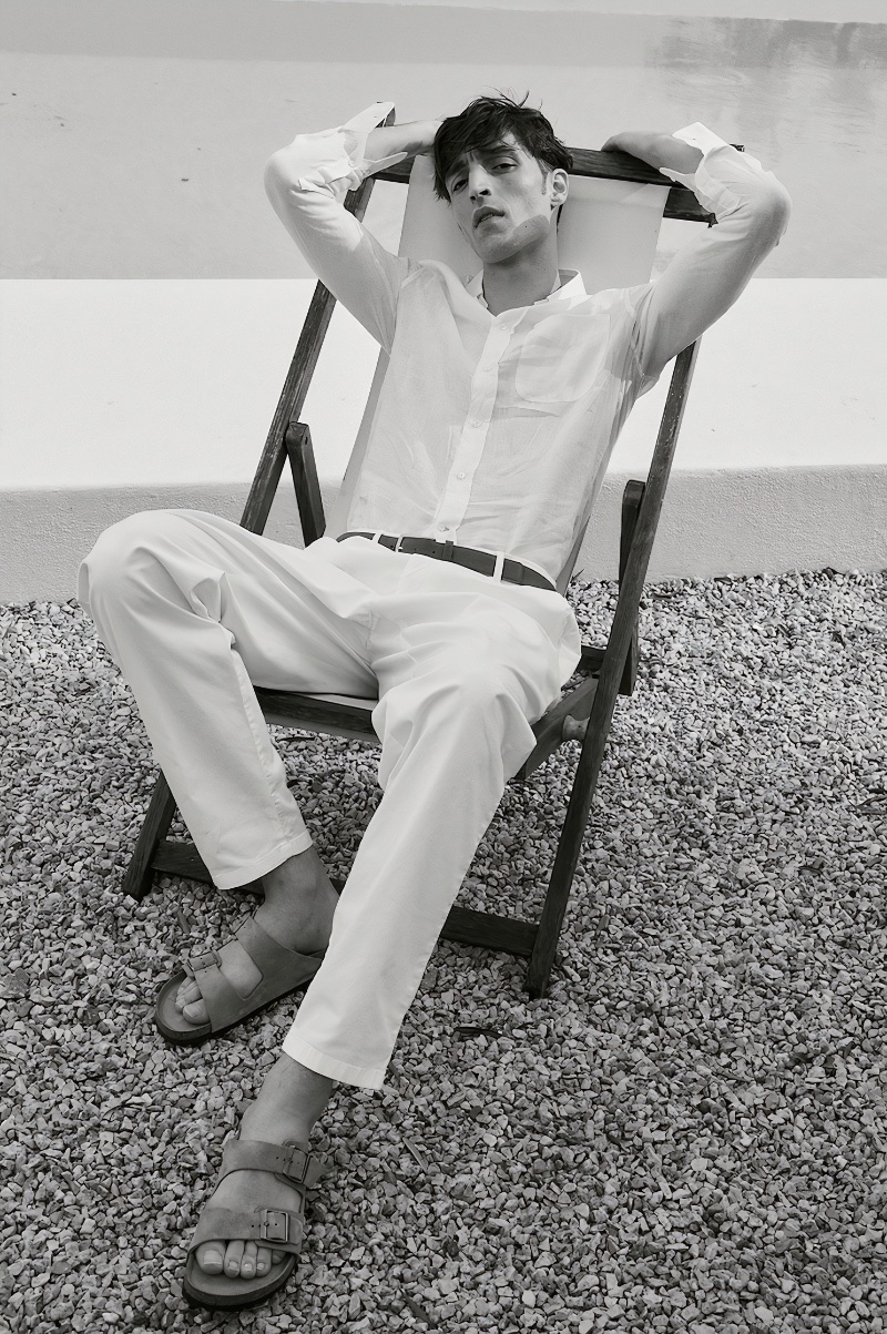 Making a case for all-white dressing, Luca Jamal models a Brunello Cucinelli linen shirt with Giorgio Armani cotton gabardine pants, and a Zegna triple stitch belt. 