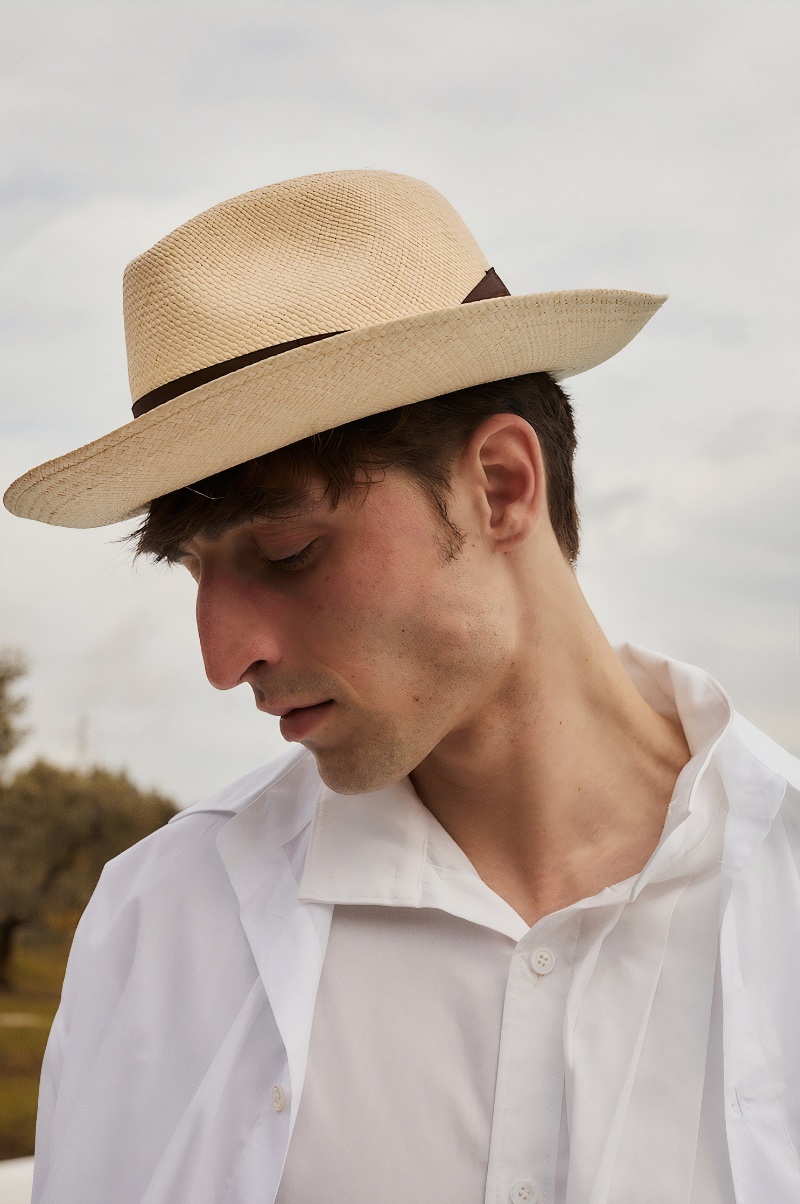 Taking the spotlight, Luca Jamal dons a Borsalino Amedeo straw hat with a Yohji Yamamoto cotton collar shirt and Jacquemus oversized short-sleeve shirt.