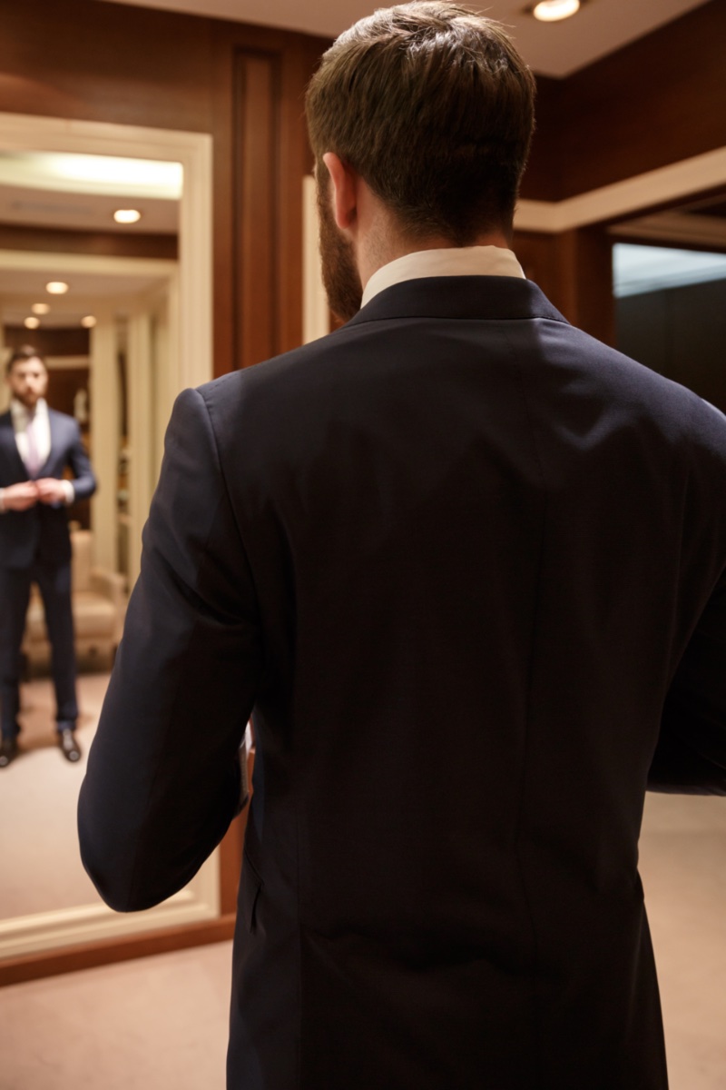 Man Putting on Suit