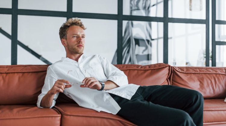 Man Relaxing on Leather Couch